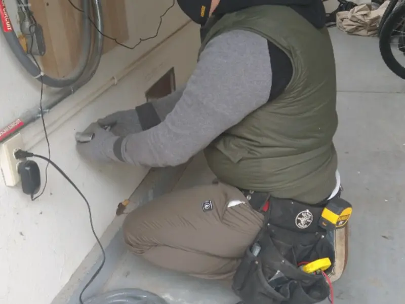 Electrician performing outlet wiring in a Richland Center garage